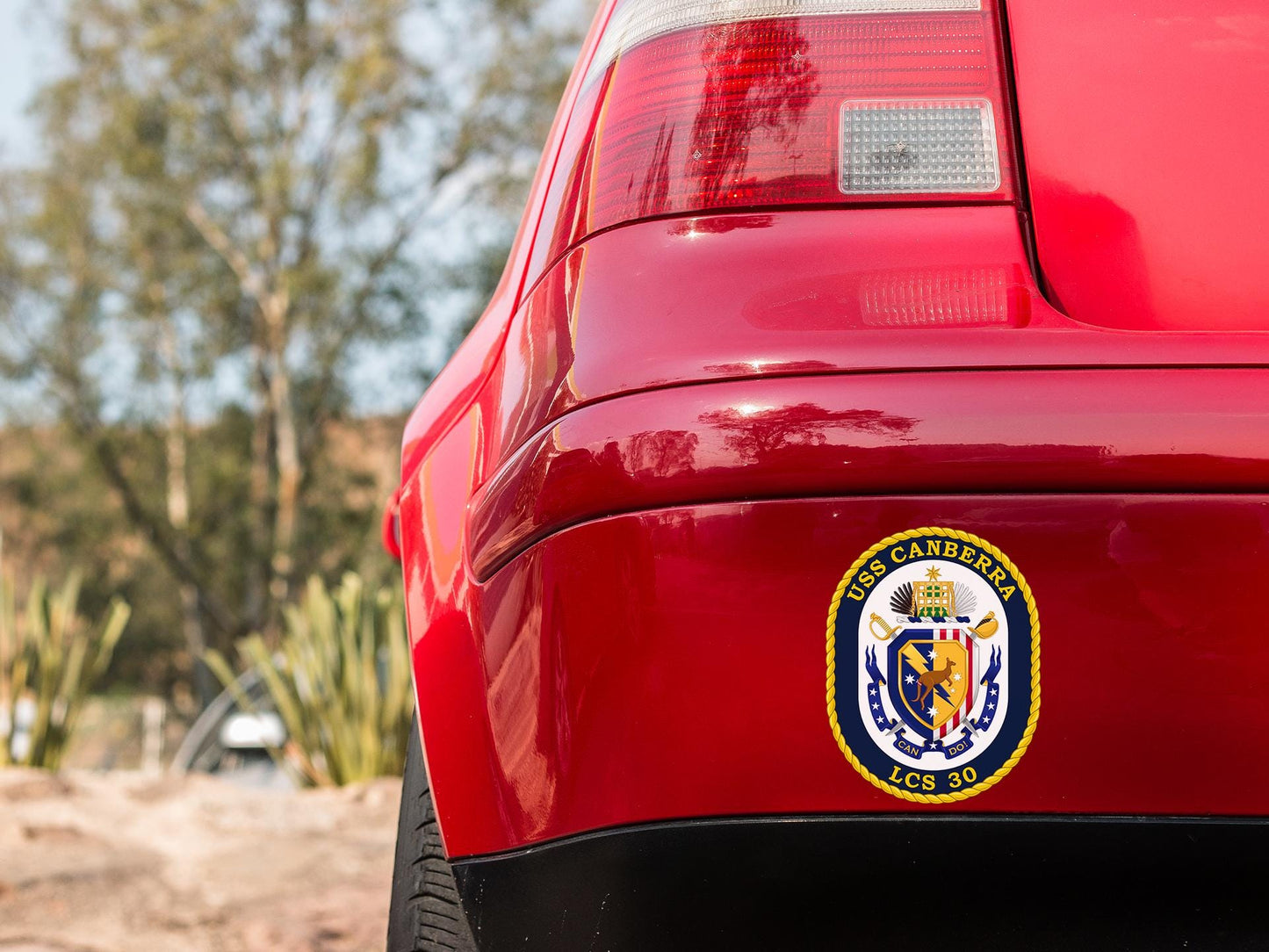 a close up of the emblem on a red car