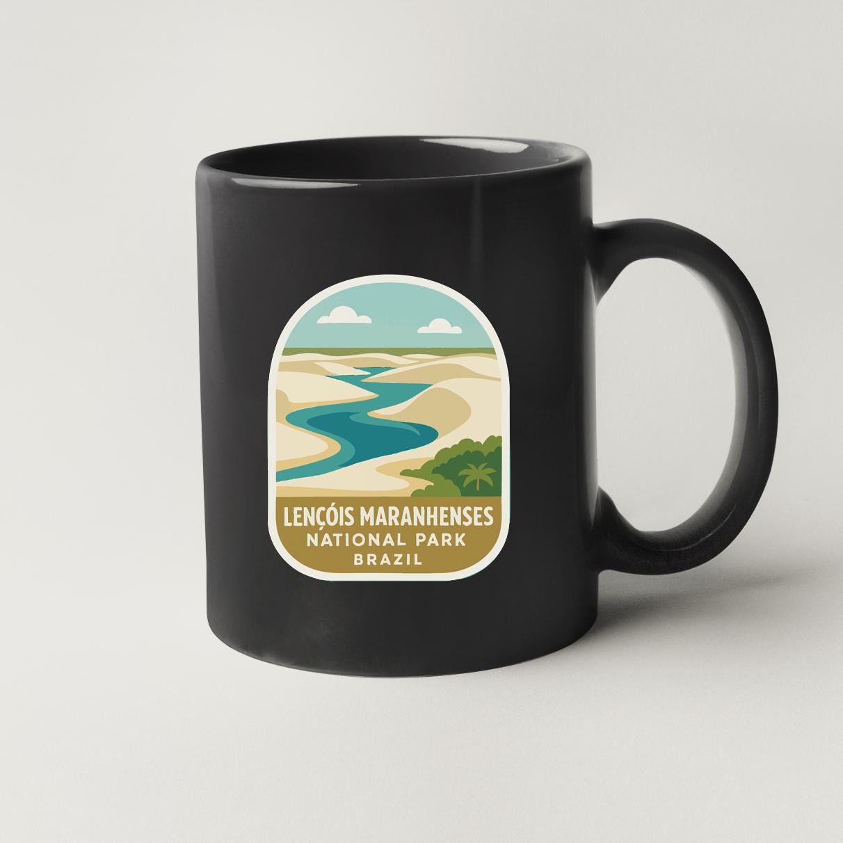 A black coffee mug with a label that says "LENCÔS MARANHENESES NATIONAL PARK BRAZIL".