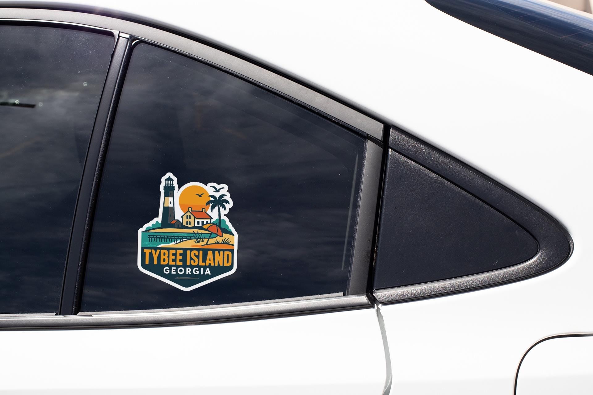 A sticker on the side of a car window, depicting a lighthouse and the text "TYBEE ISLAND GEORGIA".