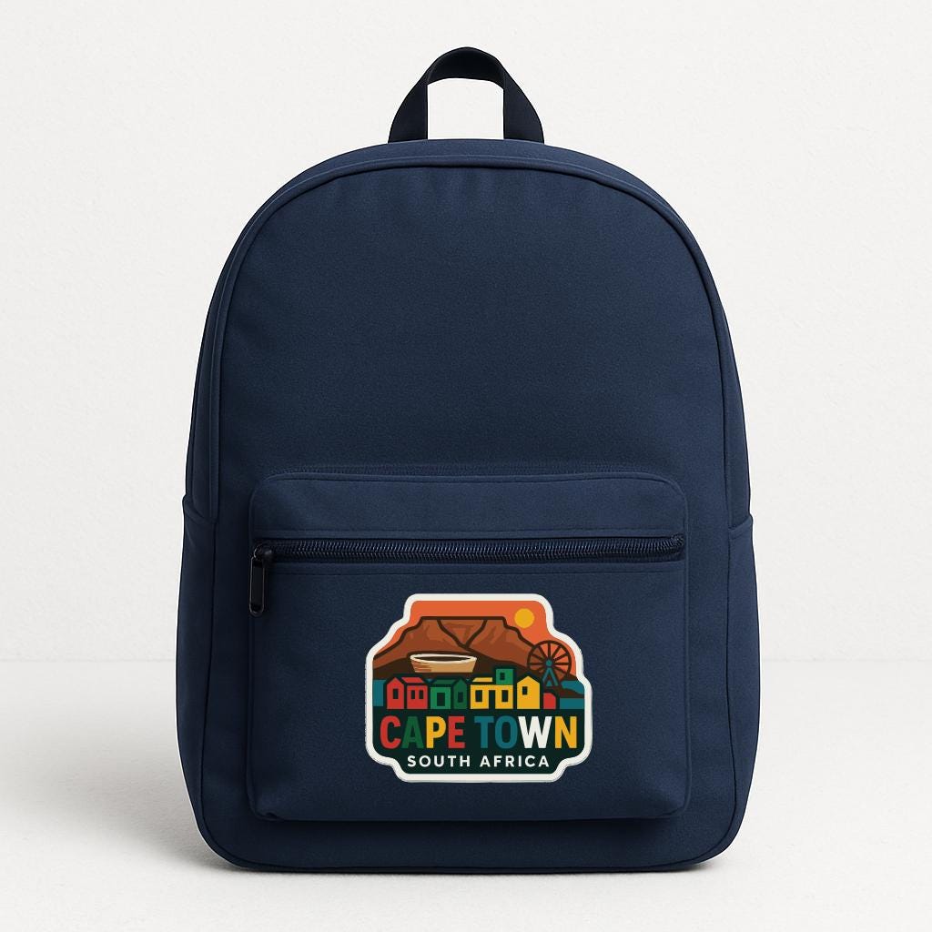 A navy blue backpack with a colorful graphic on the front, depicting a scenic view of Cape Town, South Africa.
