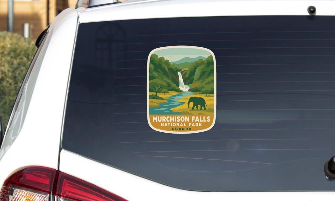 A sticker on the rear window of a car, depicting a scenic landscape with a waterfall and a lone elephant.