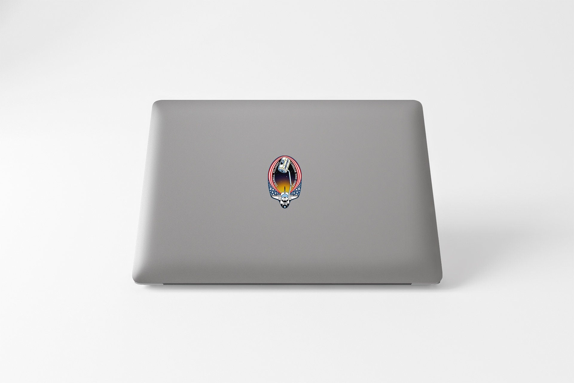 a laptop with a sticker of a cat on it