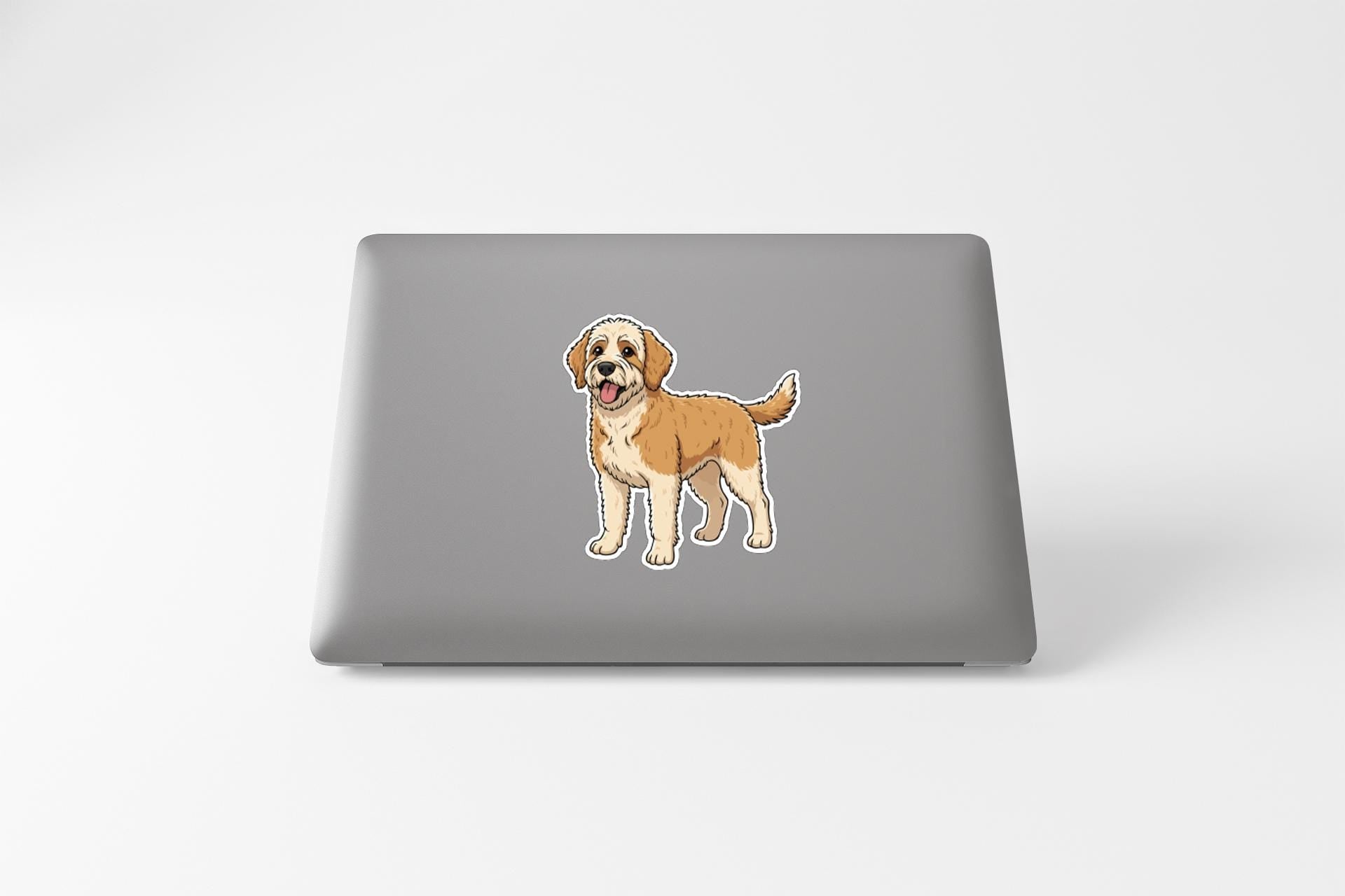 A sticker of a cartoon dog on the back of a laptop computer.