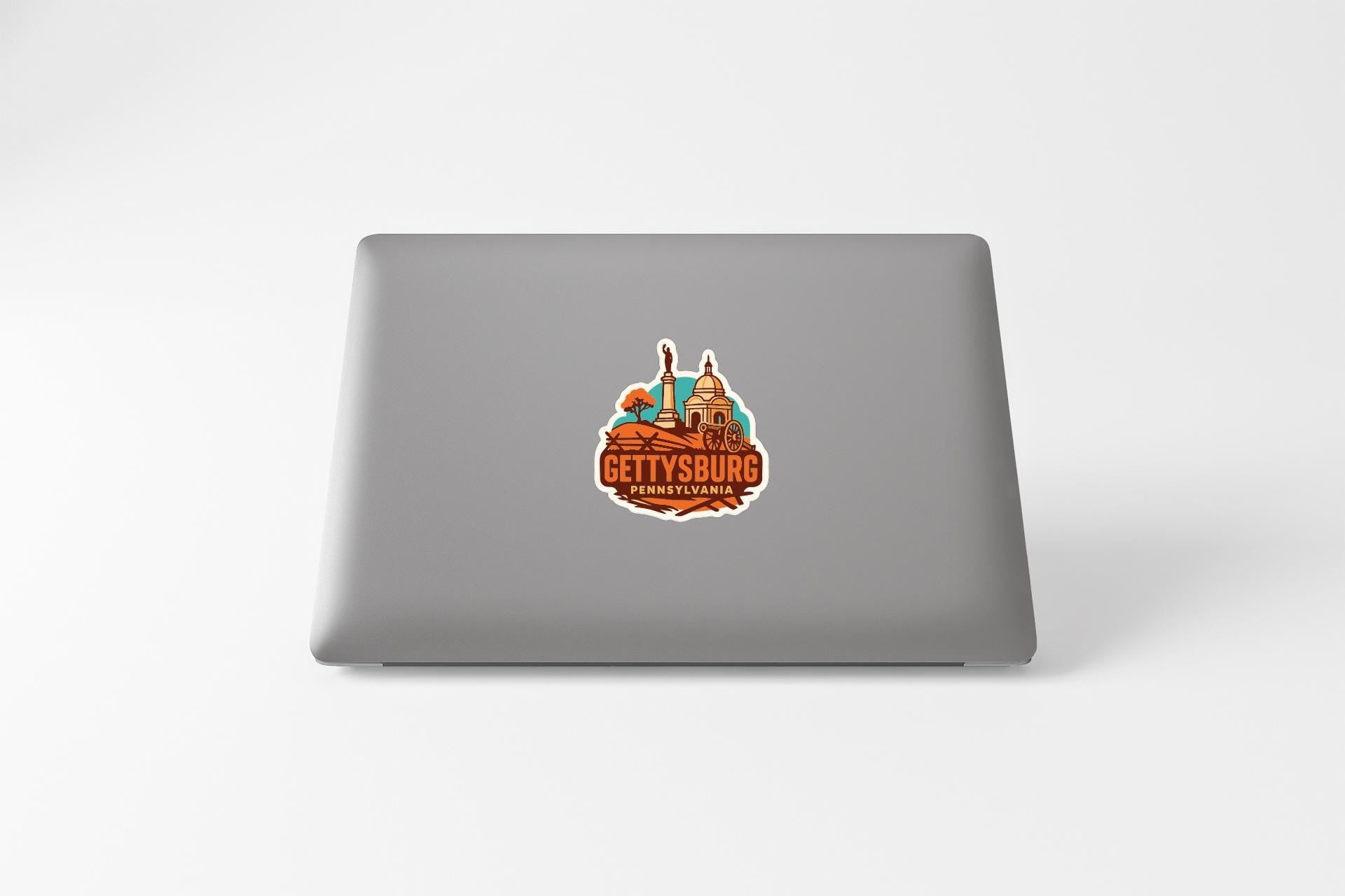 A sticker on the back of a laptop displaying the image of a city skyline with the text "GETTYSBURG" prominently featured.