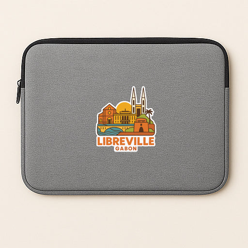 A gray laptop sleeve with a colorful graphic of a city skyline and the text "LIBREVILLE GABON" printed on it.
