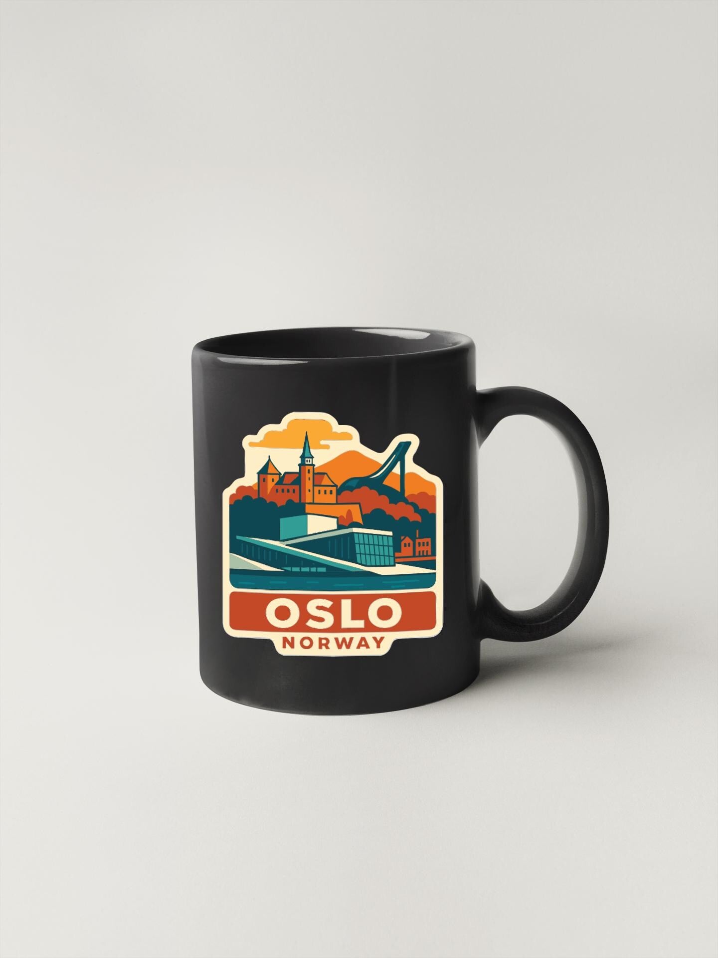A black coffee mug with a colorful graphic depicting the city of Oslo, Norway.