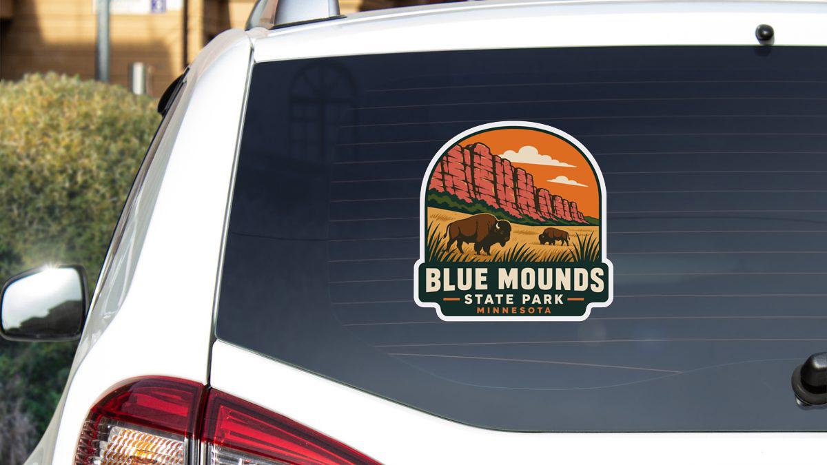 A sticker on the rear window of a vehicle that says "BLUE MOUNDS STATE PARK MINNESOTA".