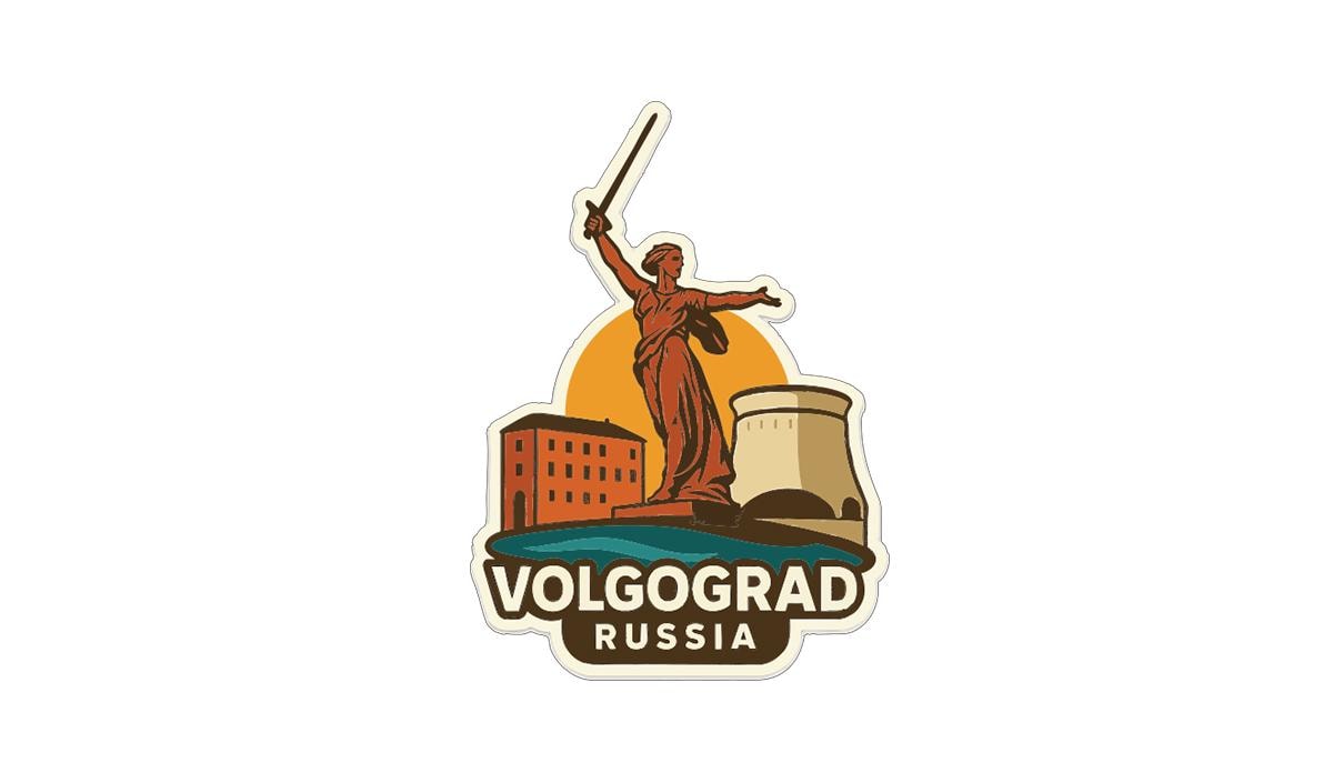a sticker or emblem with a statue of a woman holding a sword, standing on a platform, and surrounded by buildings. The text "VOLGOGRAD RUSSIA" is prominently displayed below the image.