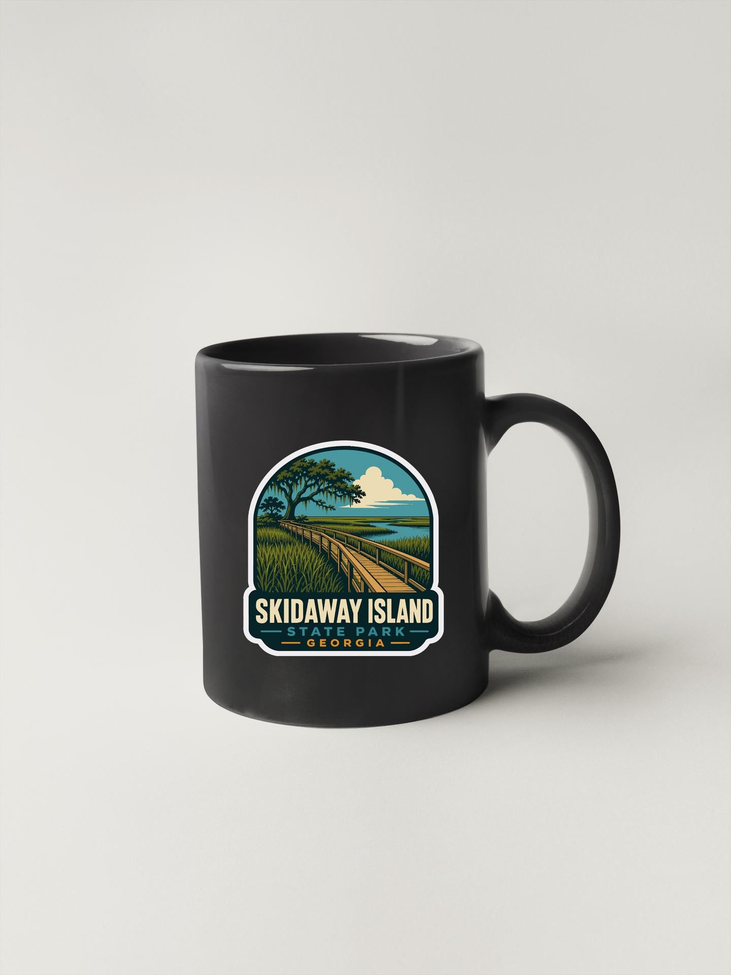 A black coffee mug with a sticker depicting Skidaway Island, Georgia.