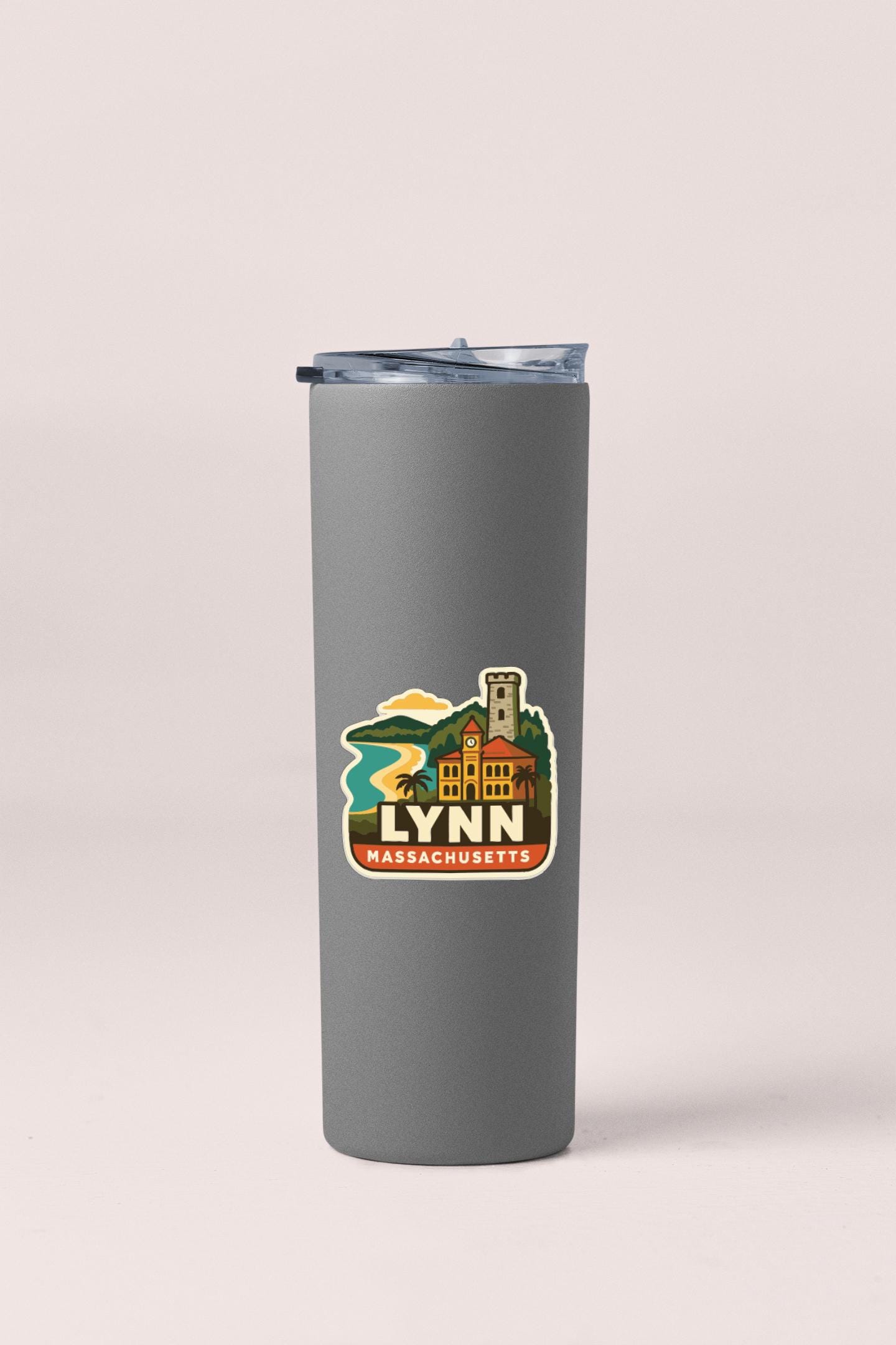A gray insulated tumbler with a lid and a sticker depicting a scenic view of Lynn, Massachusetts.