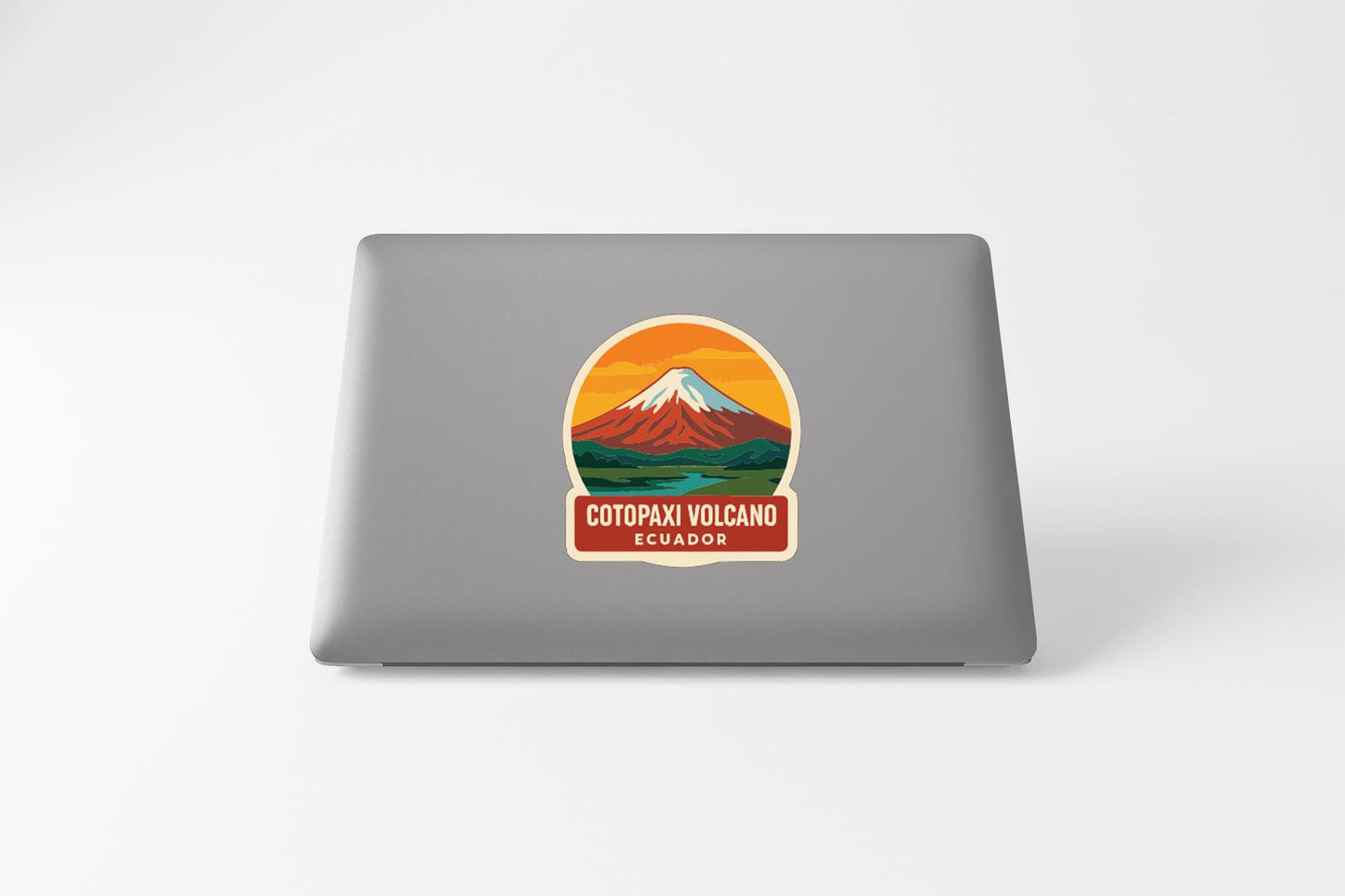a sticker with a mountain and a river, along with the text "COTOPAXI VOLCANO ECUADOR".