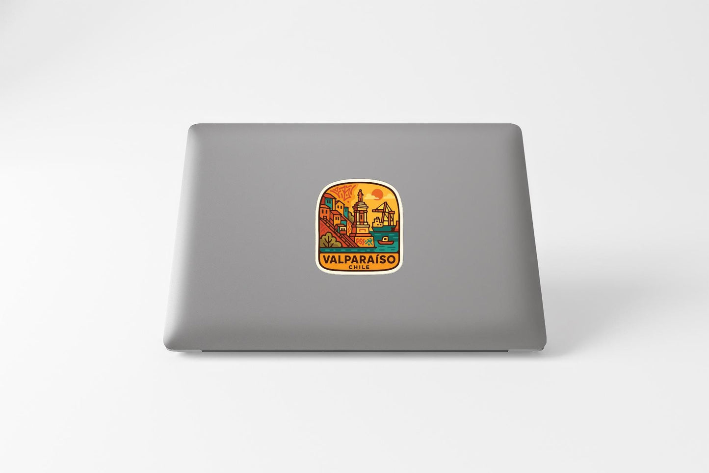 a sticker with a colorful illustration of a cityscape on a laptop.
