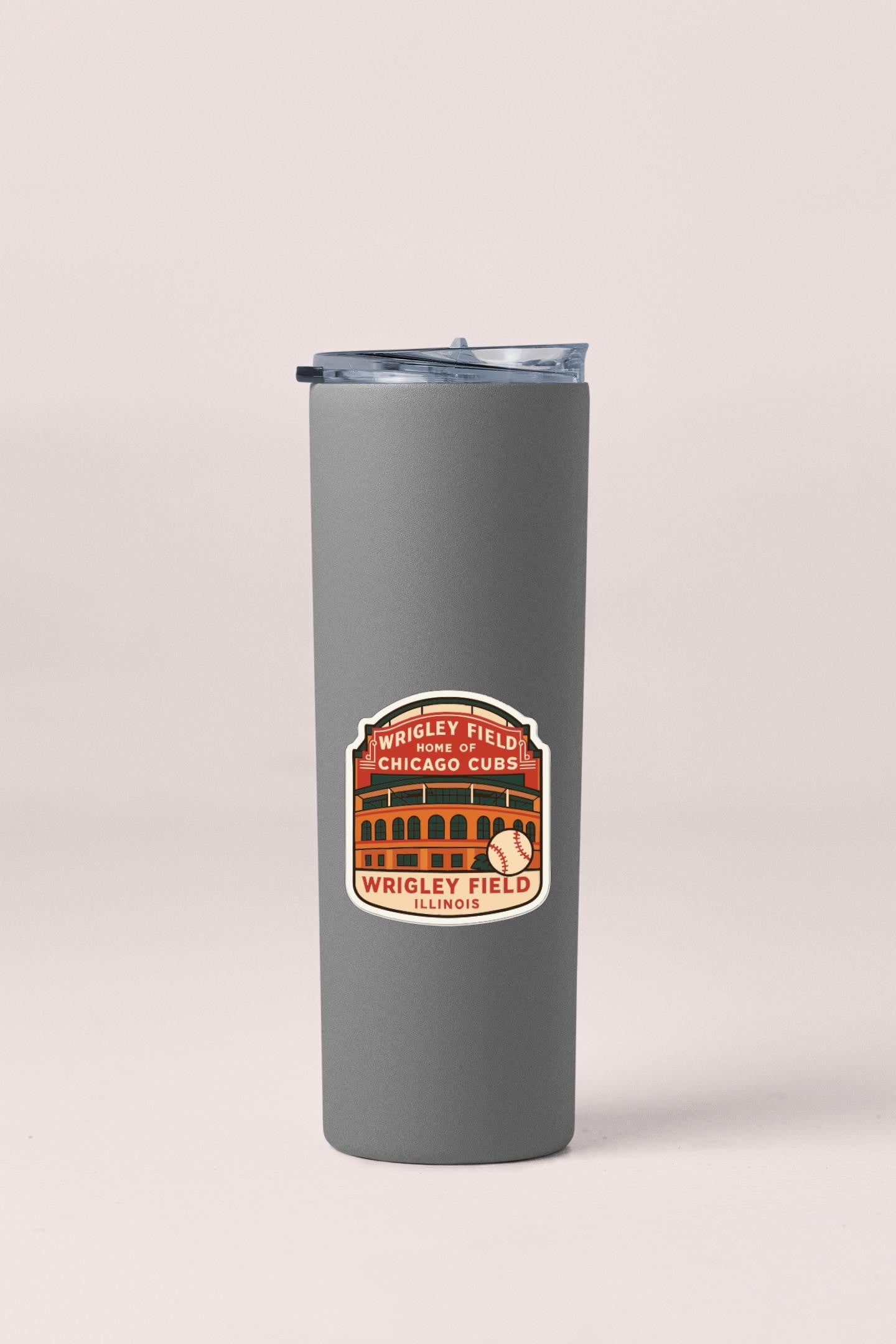 A gray insulated tumbler with a sticker depicting Wrigley Field, the home of the Chicago Cubs baseball team.
