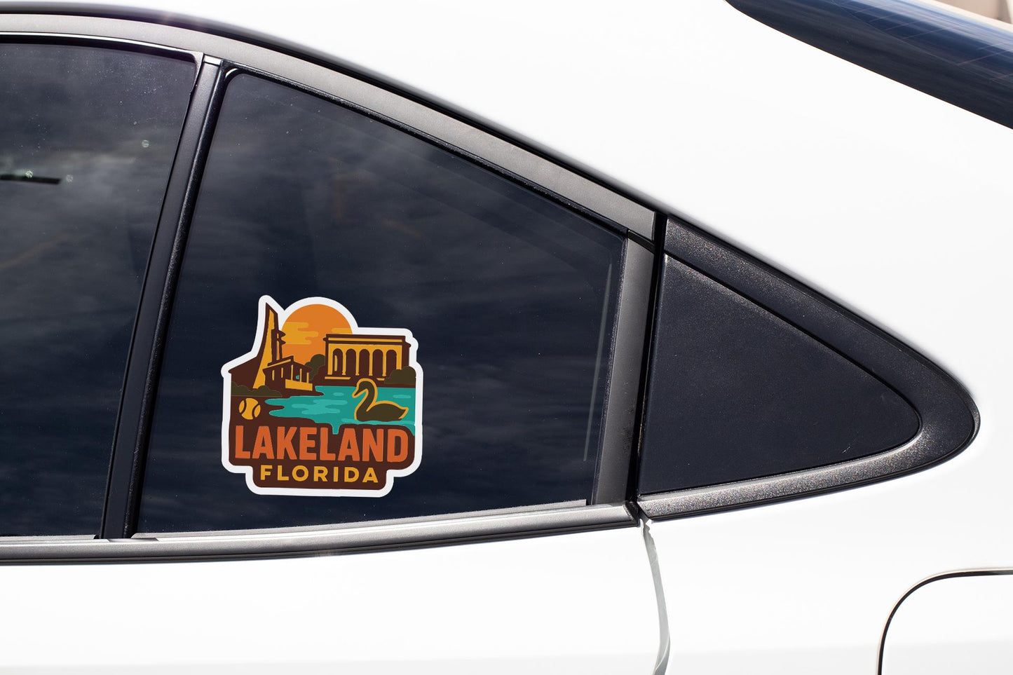 A sticker on the side of a car window, depicting a scenic view of Lakeland, Florida.
