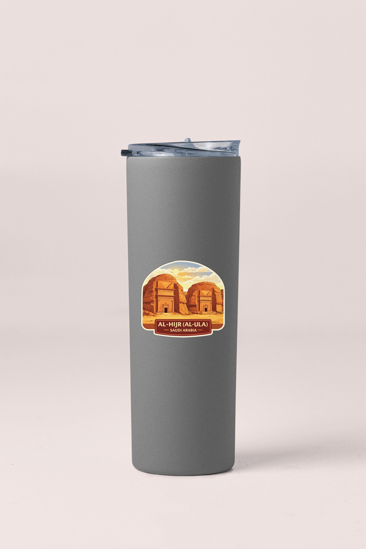 A gray tumbler with a sticker depicting a desert landscape and the text "AL-HURU AL-ULA" and "SAUDIA ARABIA".