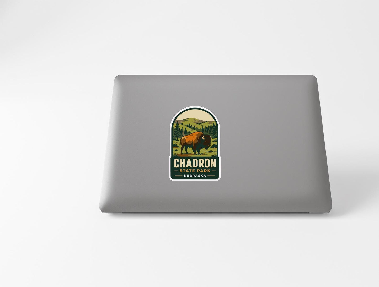a sticker on a laptop with a bison and a forest scene, along with the text "CHADRON STATE PARK NEBRASK, NEVADA".