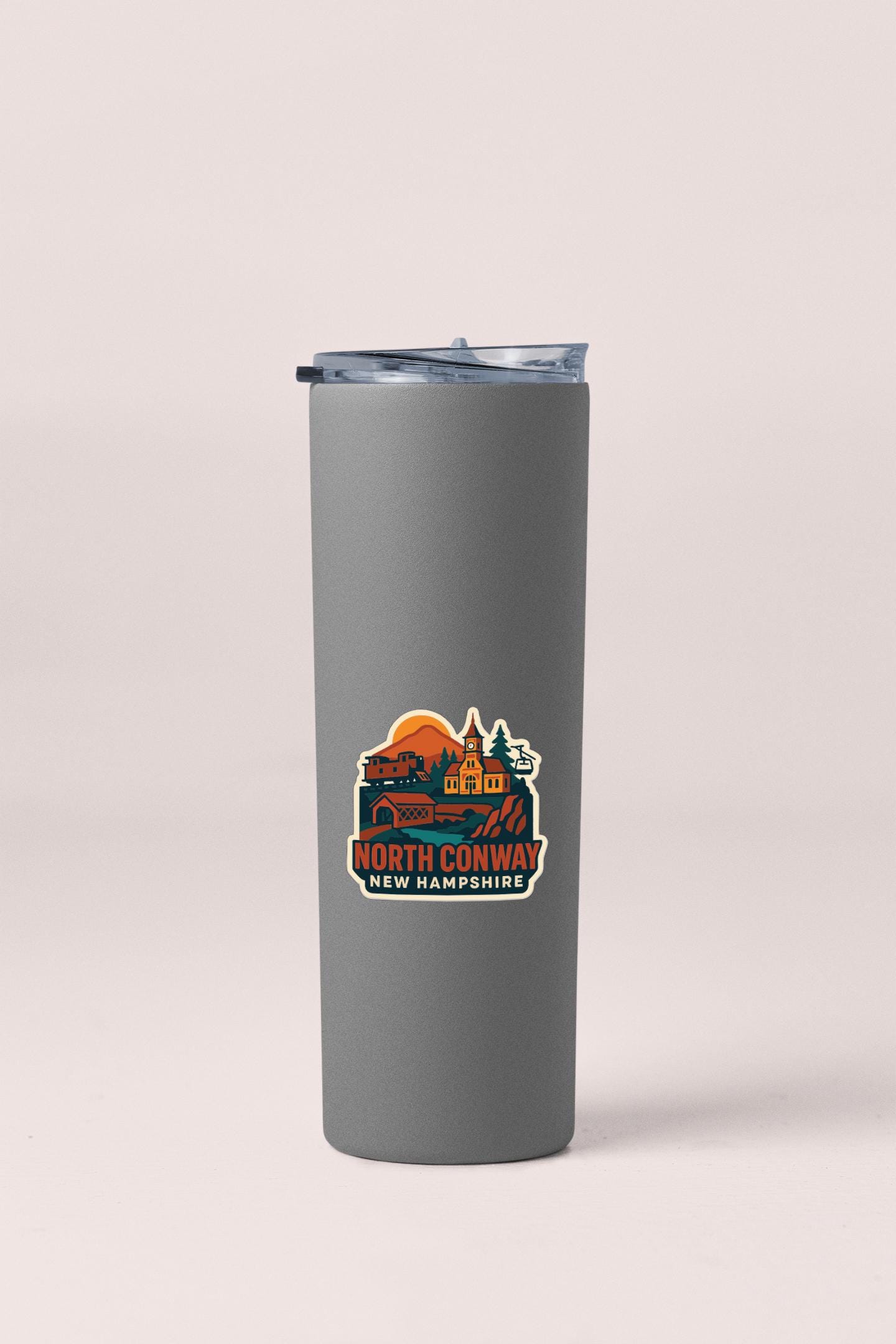 A gray insulated tumbler with a printed label that says "NORTH CONWAY NEW HAMPSTEAD".
