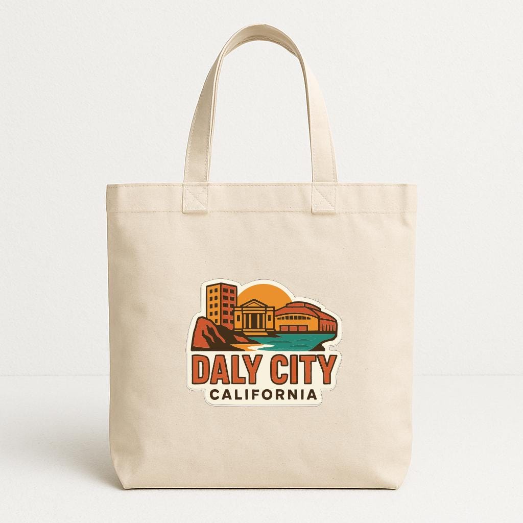 A beige tote bag with a graphic design featuring a cityscape and the text "Daly City, California" printed on it.