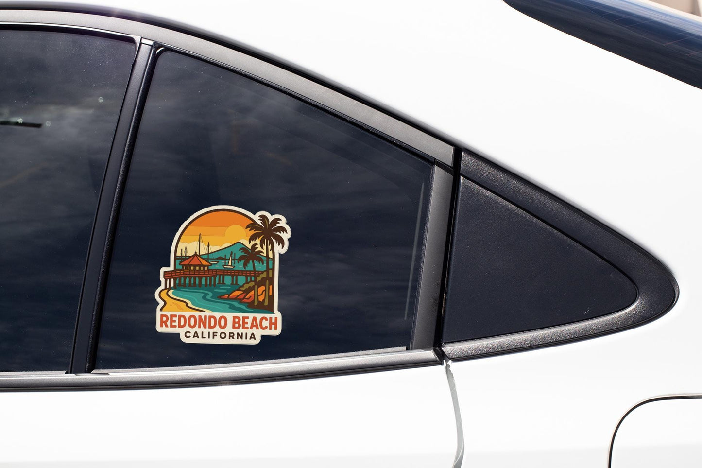 A sticker on the side of a car window, depicting a beach scene with palm trees and a sunset.