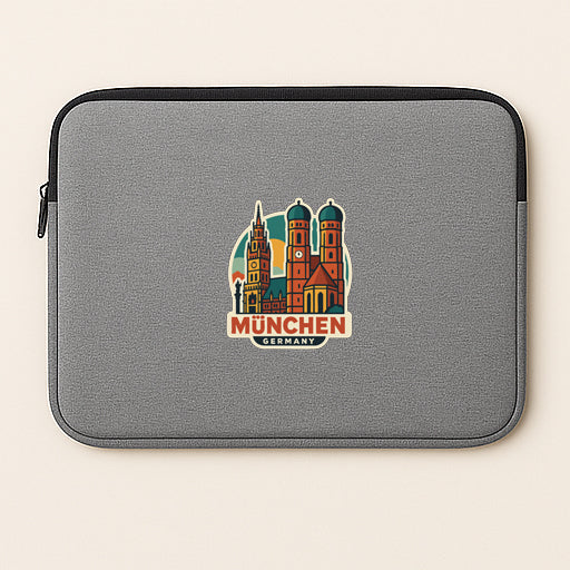 A gray laptop sleeve with a colorful sticker of the city of Munich, Germany, featuring the city's iconic landmarks.