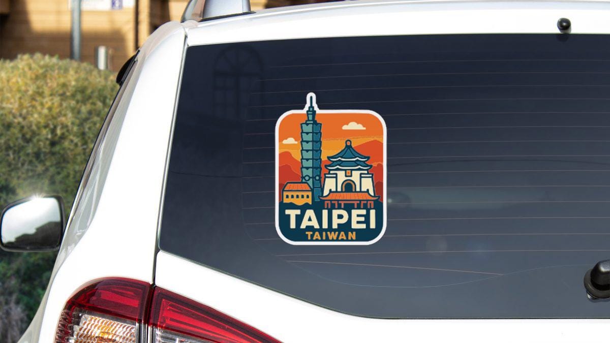 A sticker on the rear window of a car, depicting a city skyline with a tall building and a temple, along with the text "TAIpei Taiwan".