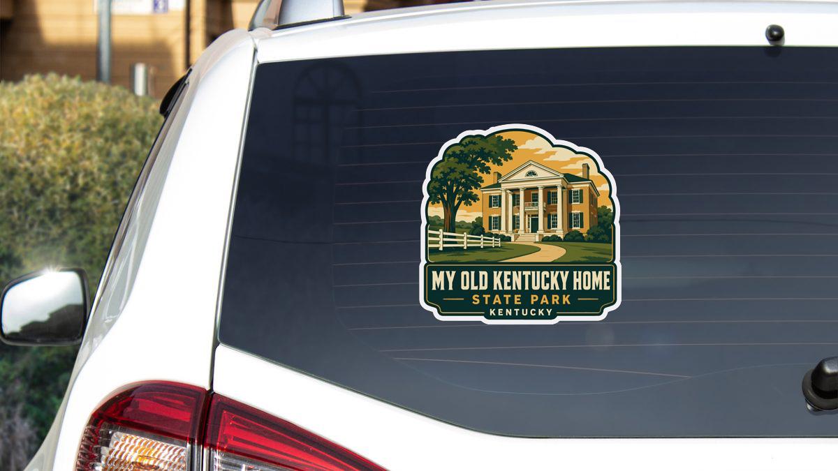 A sticker on the rear window of a vehicle, depicting a state park in Kentucky.