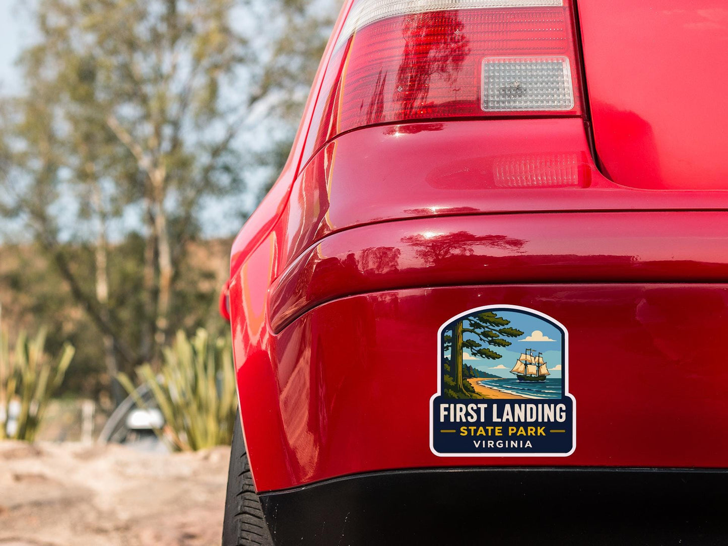 the rear end of a red car with a sticker on the back window that says "First Landing State Park Virginia".