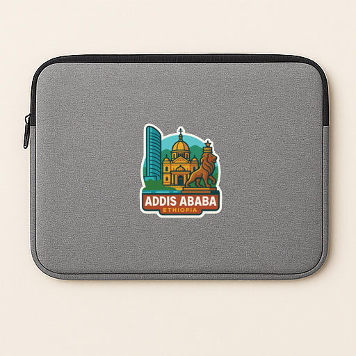a gray laptop sleeve with a sticker depicting a city skyline and a lion statue.