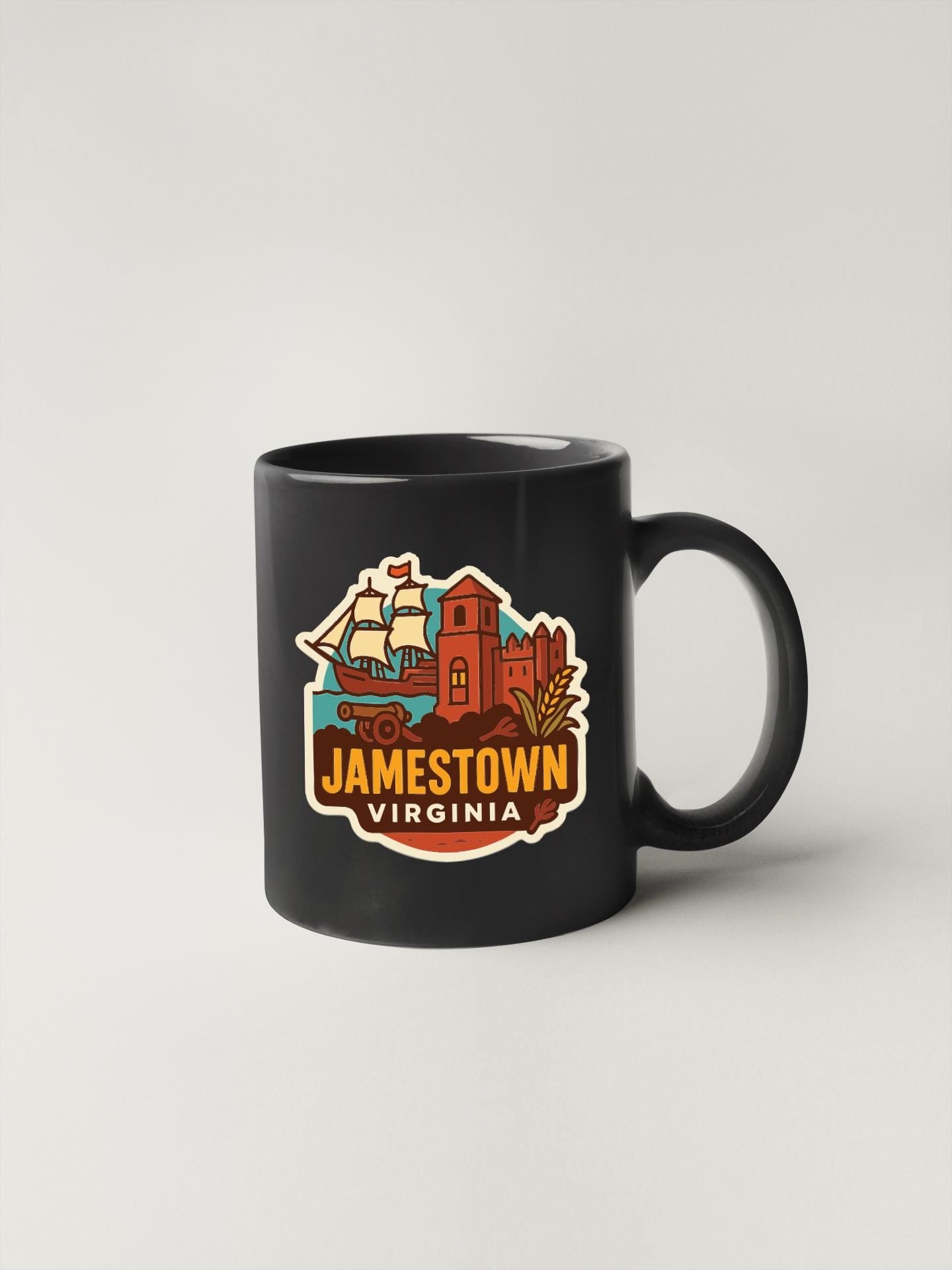 A black coffee mug with a colorful graphic design depicting landmarks and symbols associated with Jamestown, Virginia.