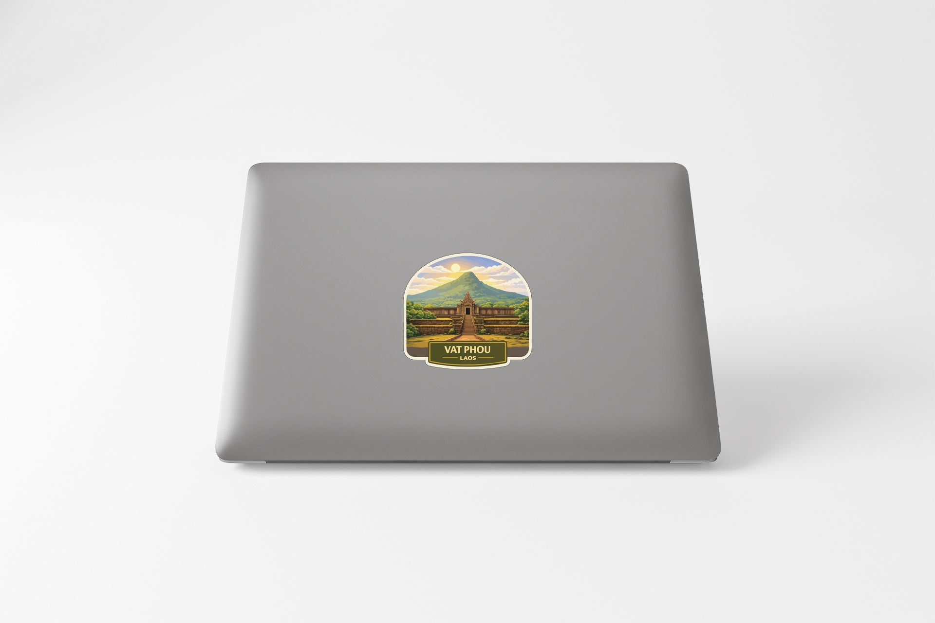 A sticker depicting a mountain landscape with a building in the background.