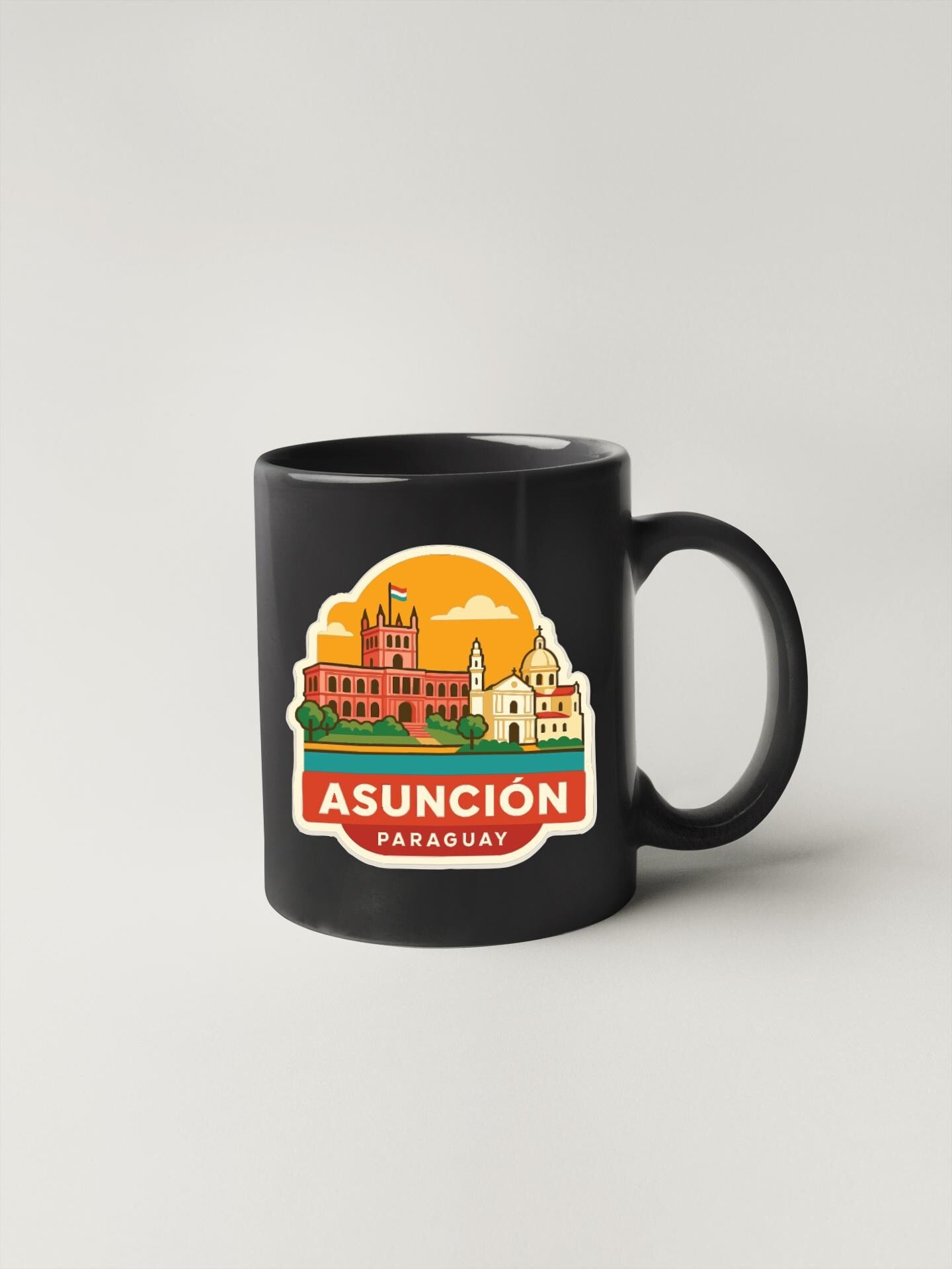 A black coffee mug with a colorful illustration of the city of Asunción, Paraguay, featuring buildings and landmarks.