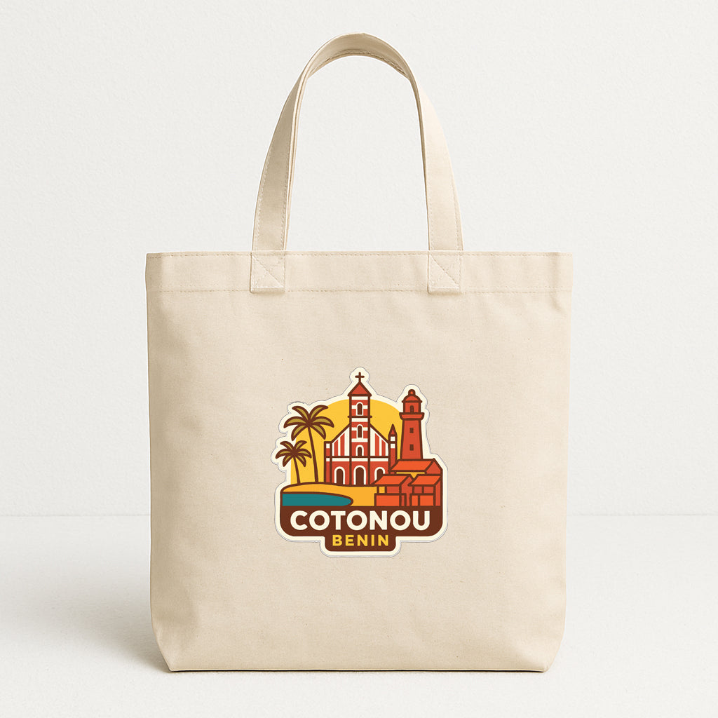 A beige tote bag with a printed design featuring a cityscape and a lighthouse, along with the text "COTONOU BENIN".