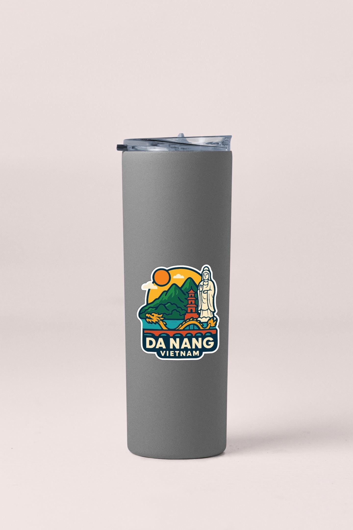 A gray insulated tumbler with a sticker depicting a scenic view of Da Nang, Vietnam.