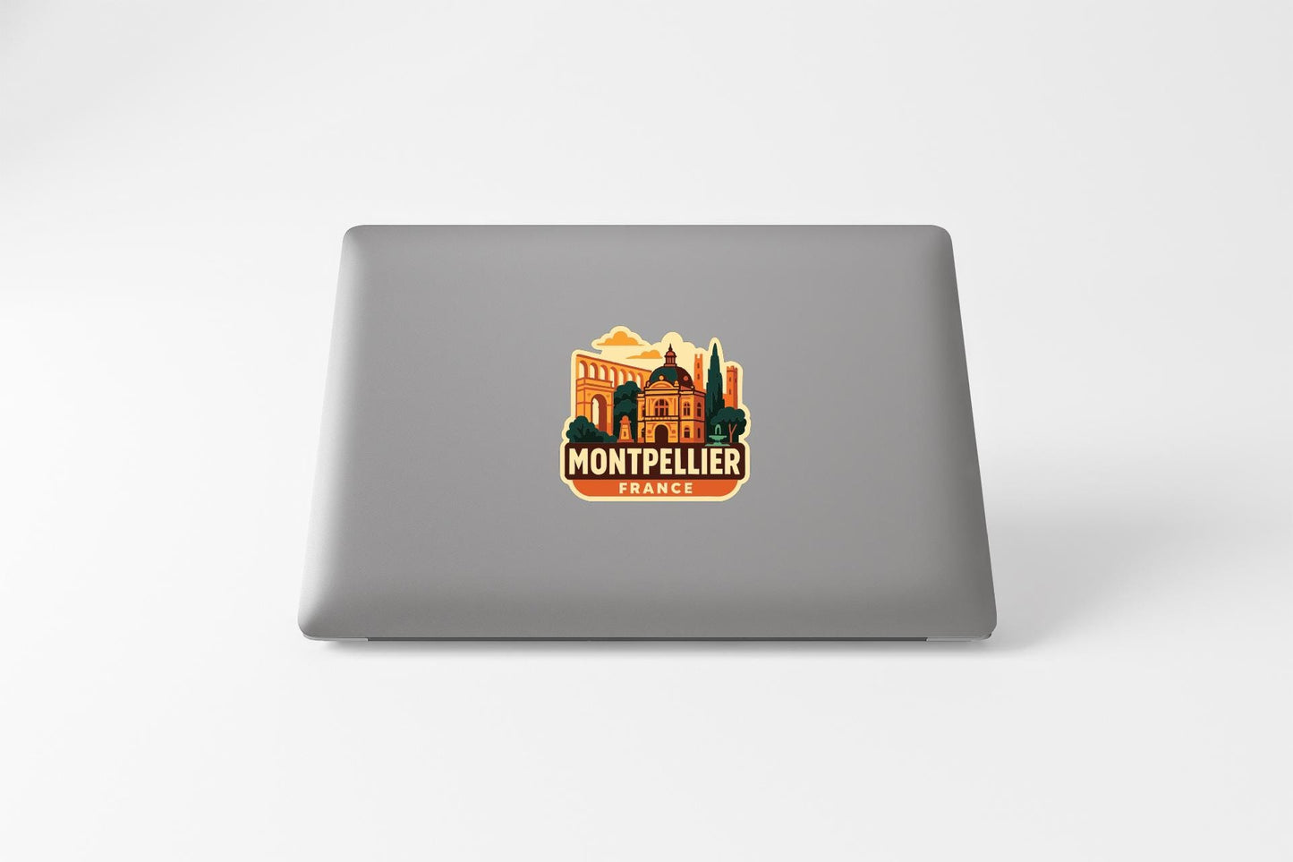a sticker or decal of the city of Montpellier, France, on the back of a laptop computer.