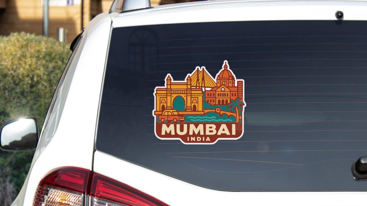 Sticker on rear window of a white car with a cityscape design.
