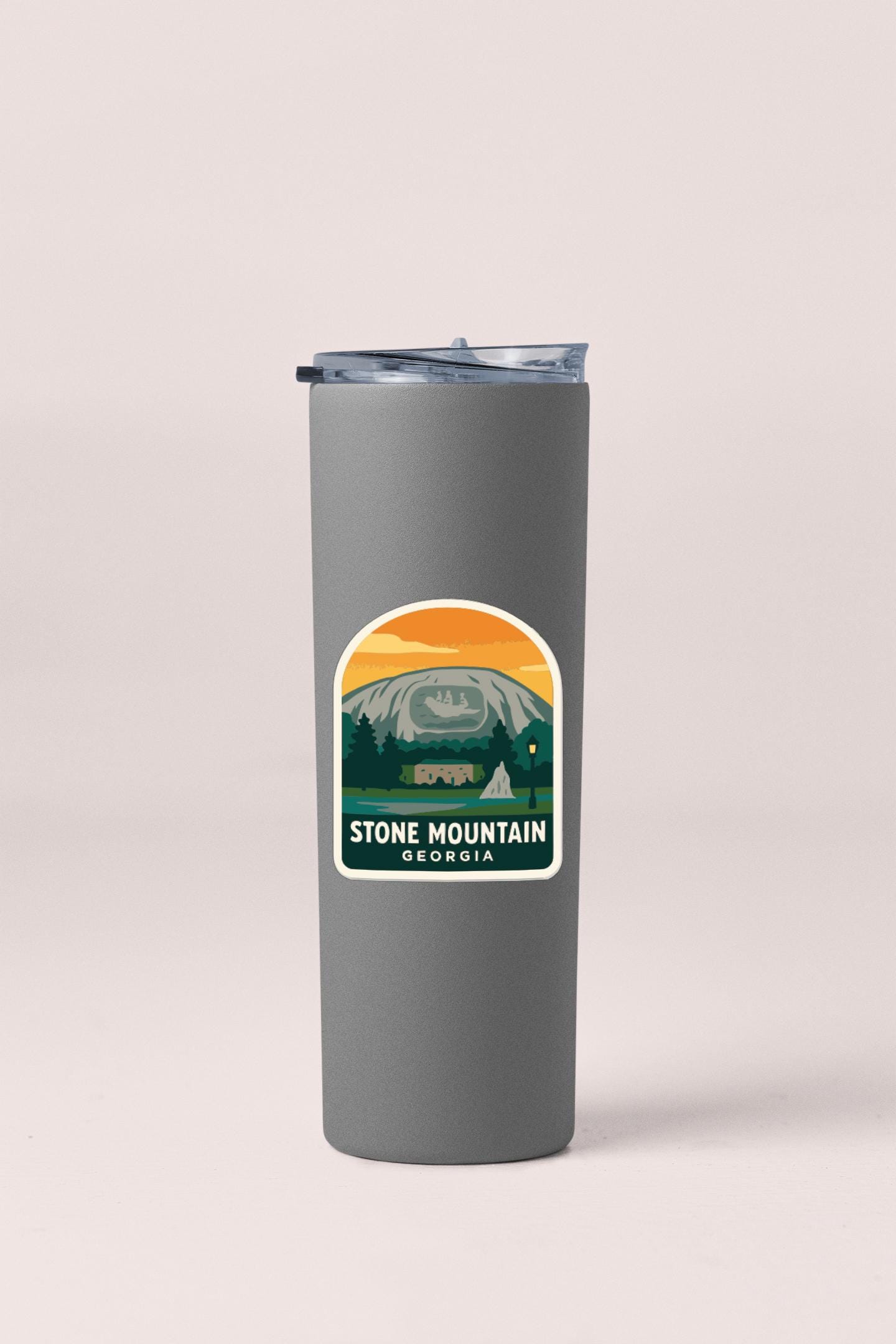 A gray insulated tumbler with a label that says "STONE MOUNTAIN GEORGIA".