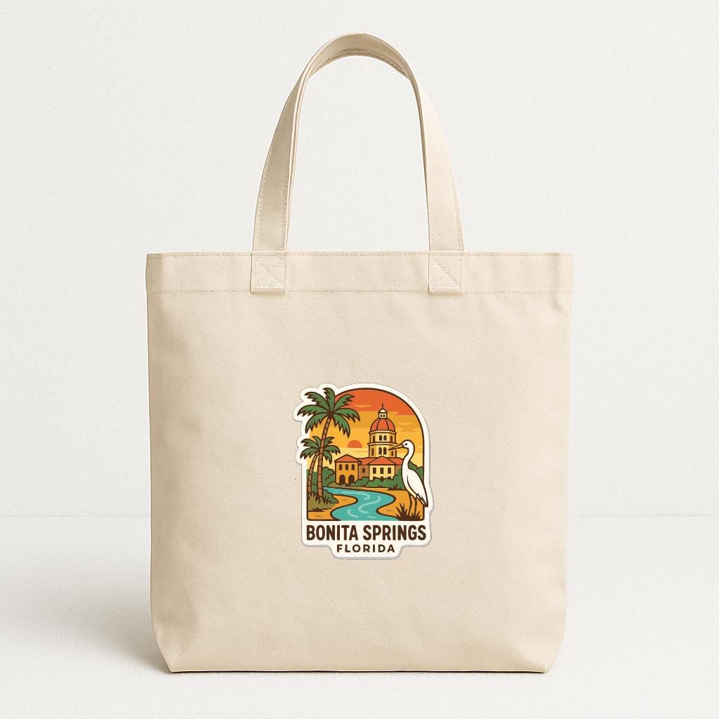 A beige tote bag with a printed design depicting a tropical scene with palm trees, a building, and a body of water.