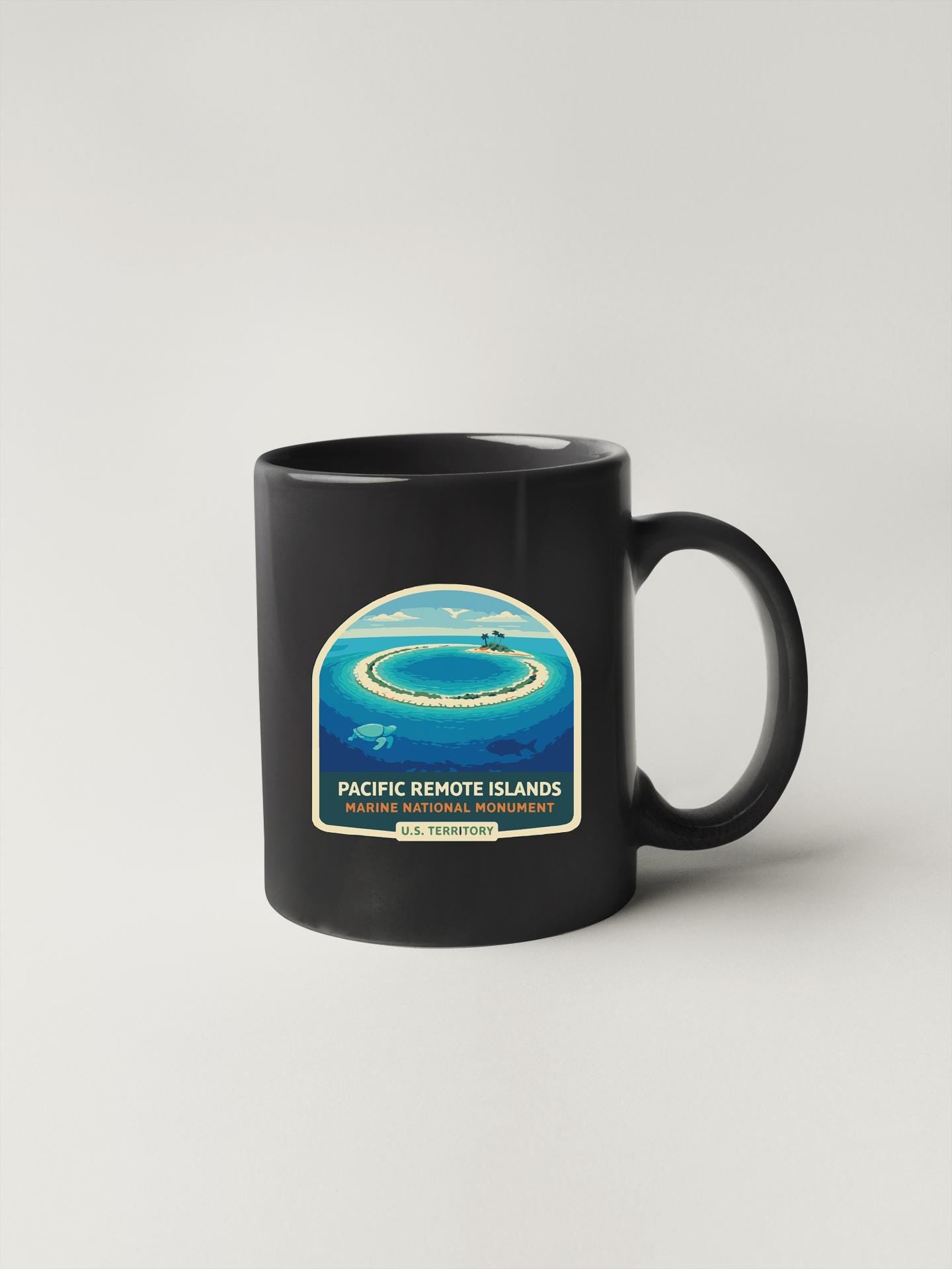 A black coffee mug with a graphic design depicting the Pacific Remote Islands, a marine national monument.