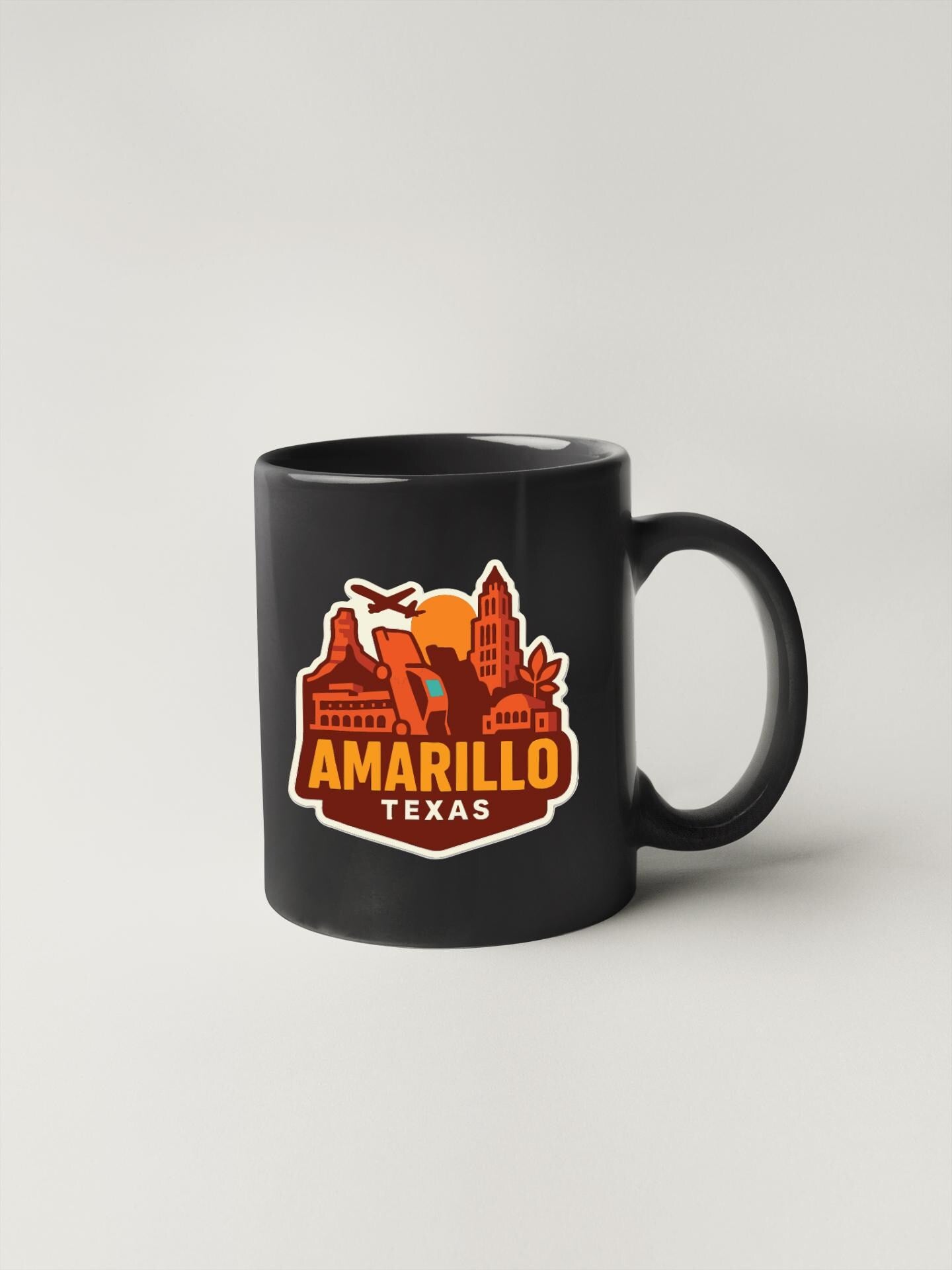 A black coffee mug with a graphic design featuring the city of Amarillo, Texas.