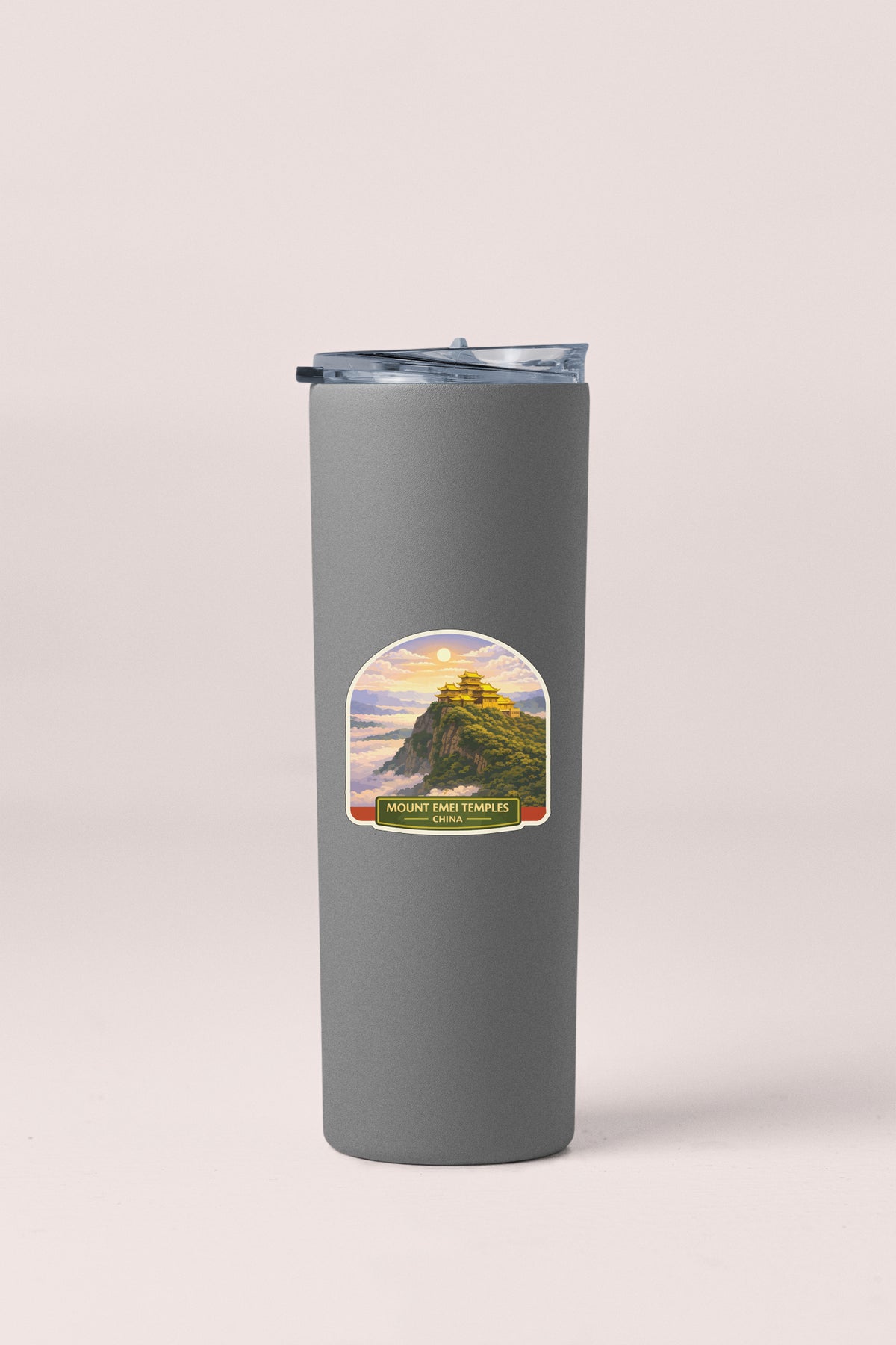 A gray insulated tumbler with a label depicting a mountain landscape and the text "MOUNT EMI TEMPLE".