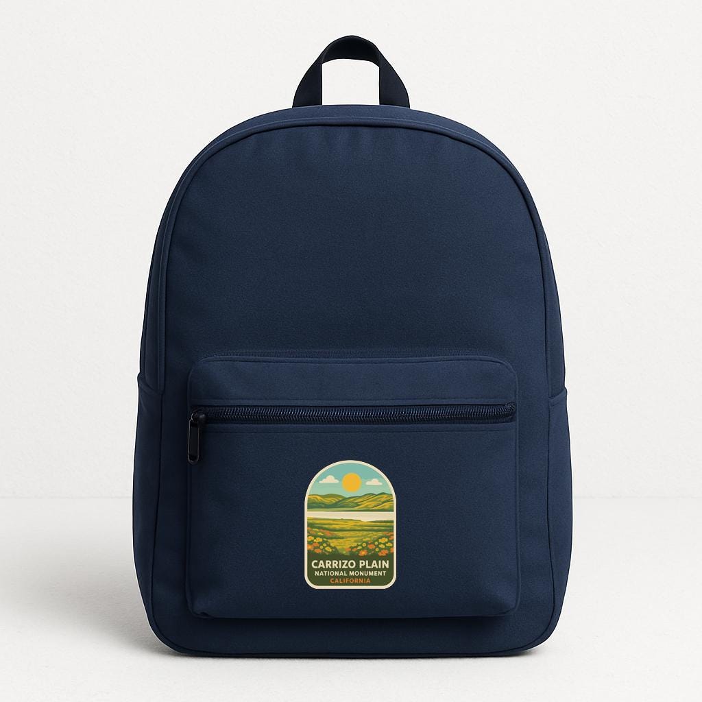 A navy blue backpack with a label that says "CARRIZO PLAIN" and "CARRIZO PLAIN NATIONAL PARK".