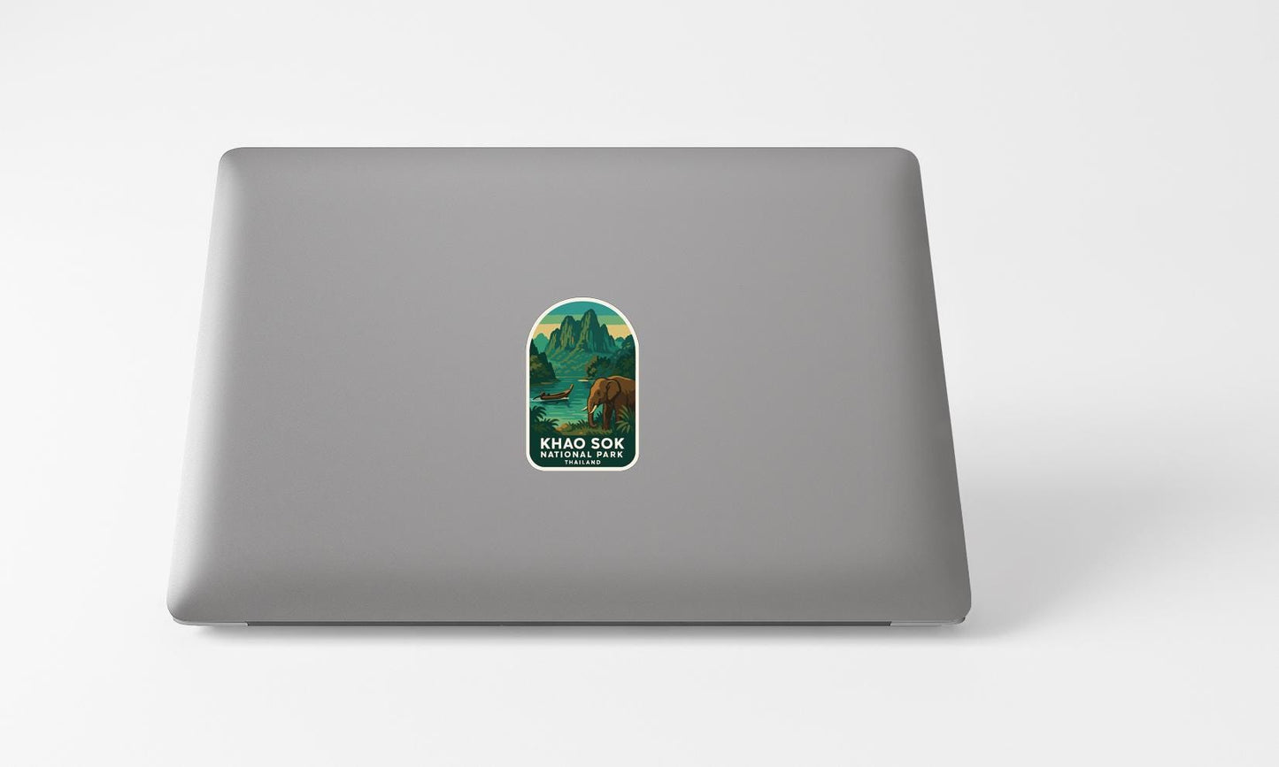 A sticker with a mountain landscape and a bear on a laptop.