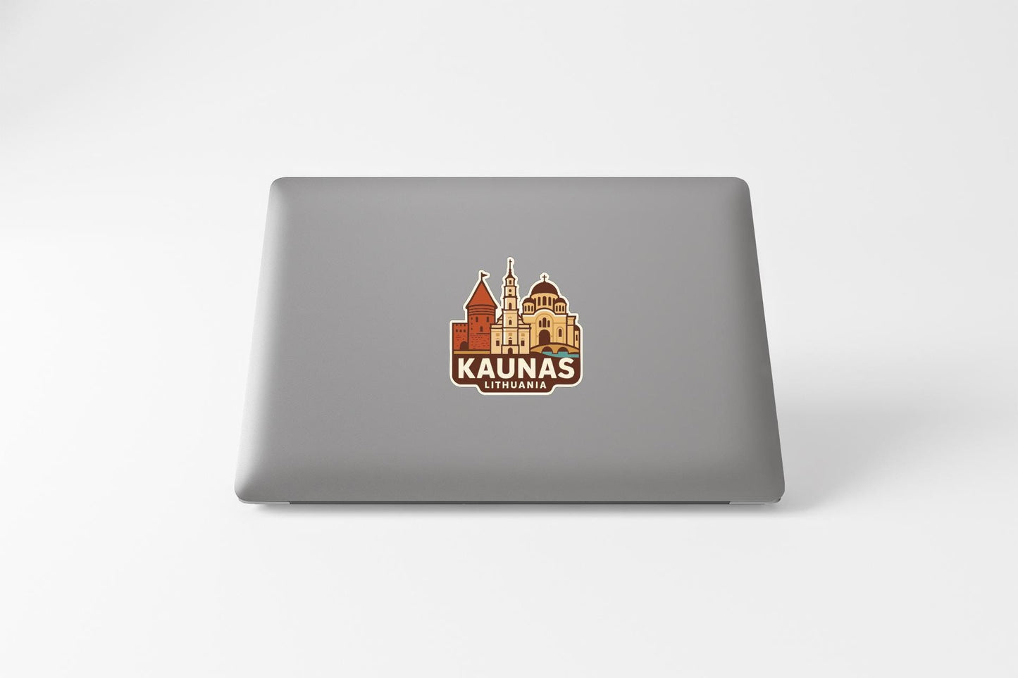 a sticker or logo of the city of Kaunas, Lithuania, on the back of a laptop computer.