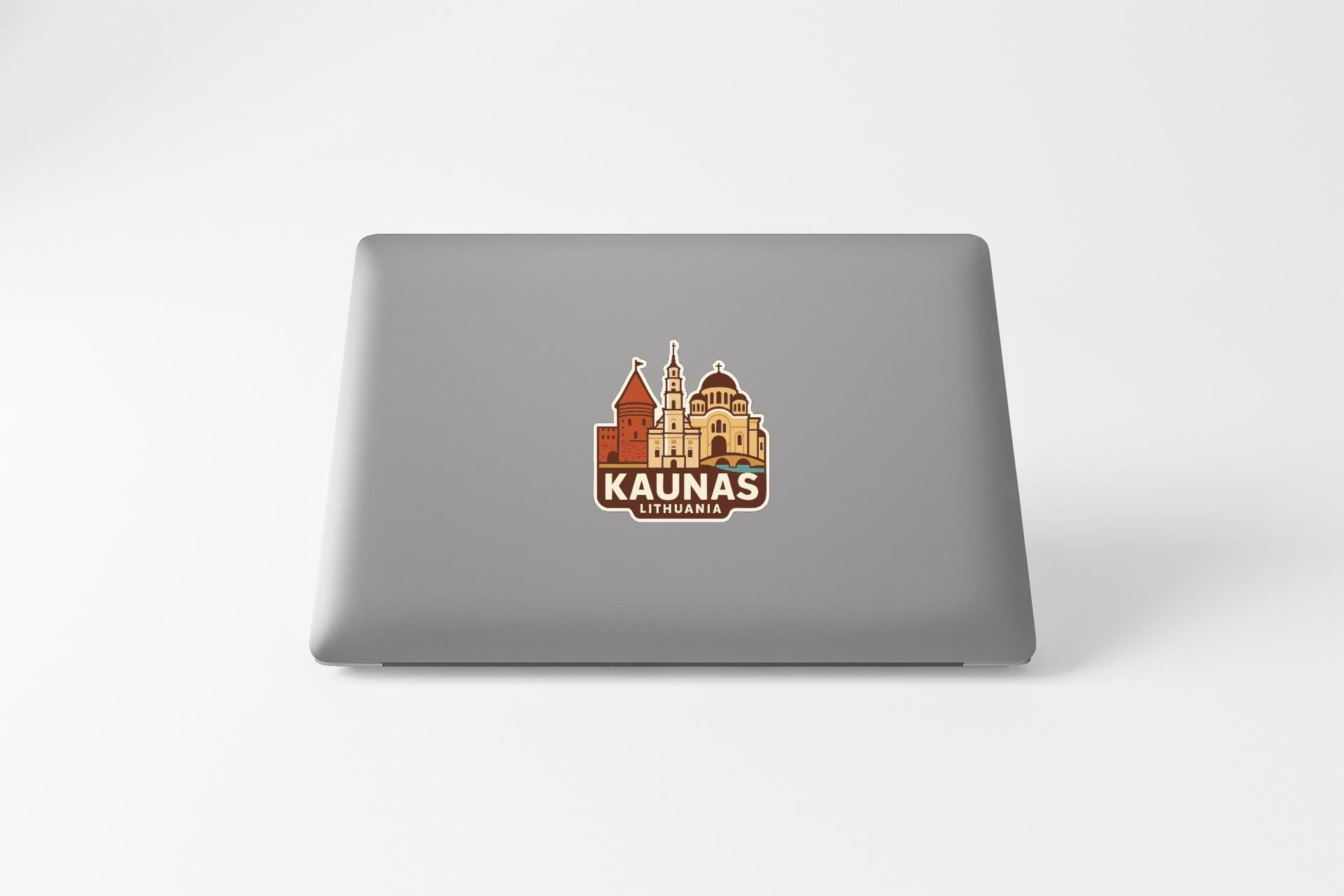 a sticker or logo of the city of Kaunas, Lithuania, on the back of a laptop computer.