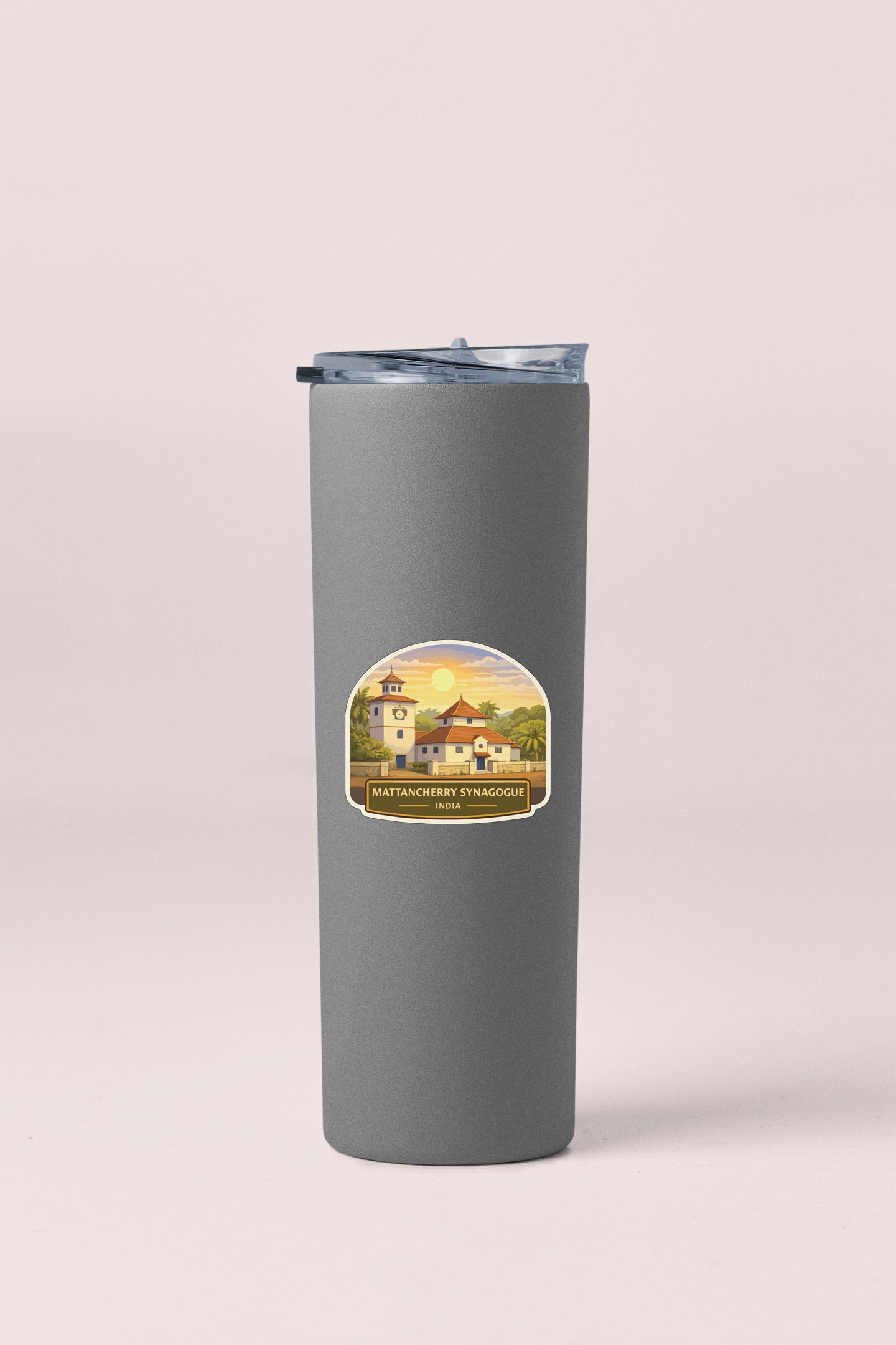 A gray insulated tumbler with a label featuring a scenic image of a building and a sunset.