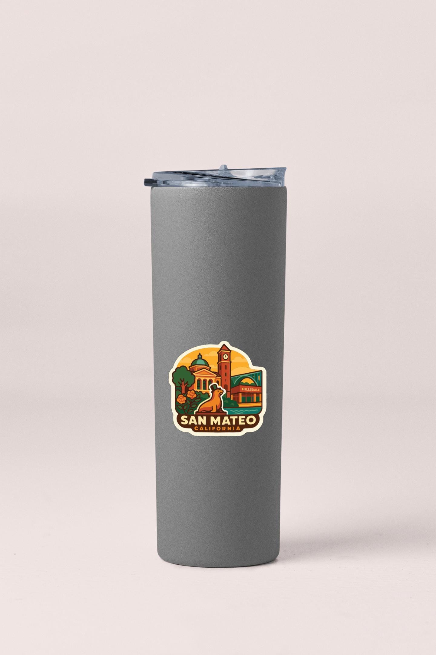 A gray insulated tumbler with a sticker depicting San Mateo, California.