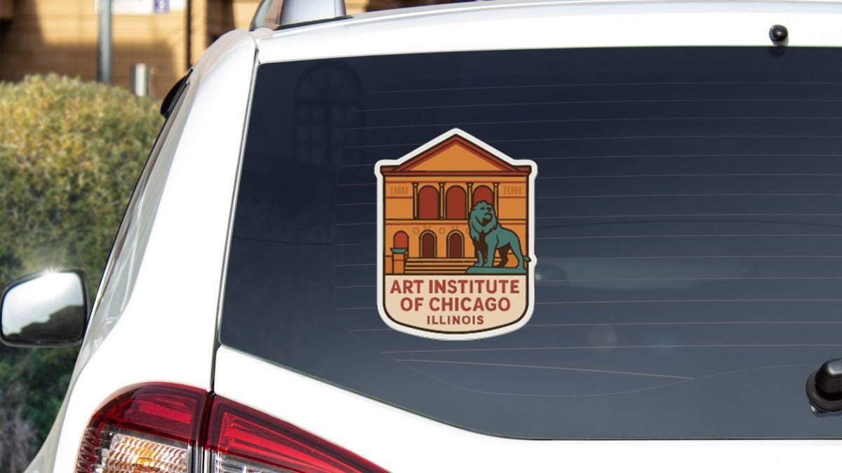 a sticker on the rear window of a white vehicle, displaying the logo of the Art Institute of Chicago, Illinois.
