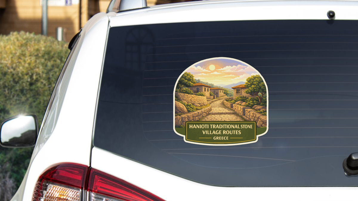 a sticker on the rear window of a car, depicting a scenic village in Greece.
