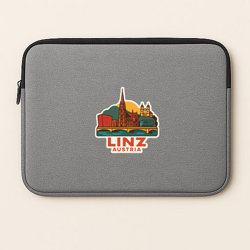 A gray laptop sleeve with a sticker depicting the city of Linz, Austria.