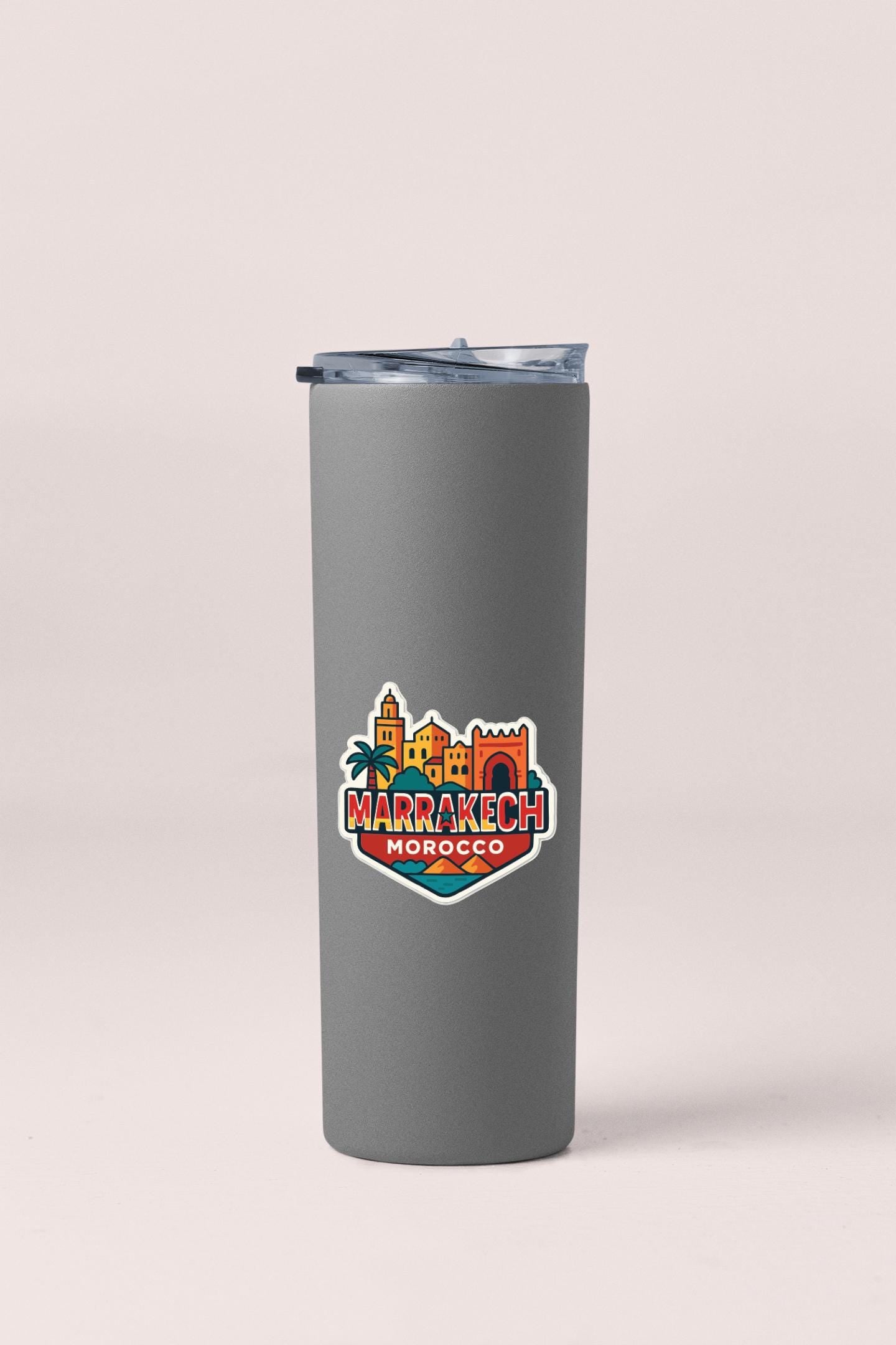 A gray insulated tumbler with a colorful logo depicting the city of Marrakech, Morocco.